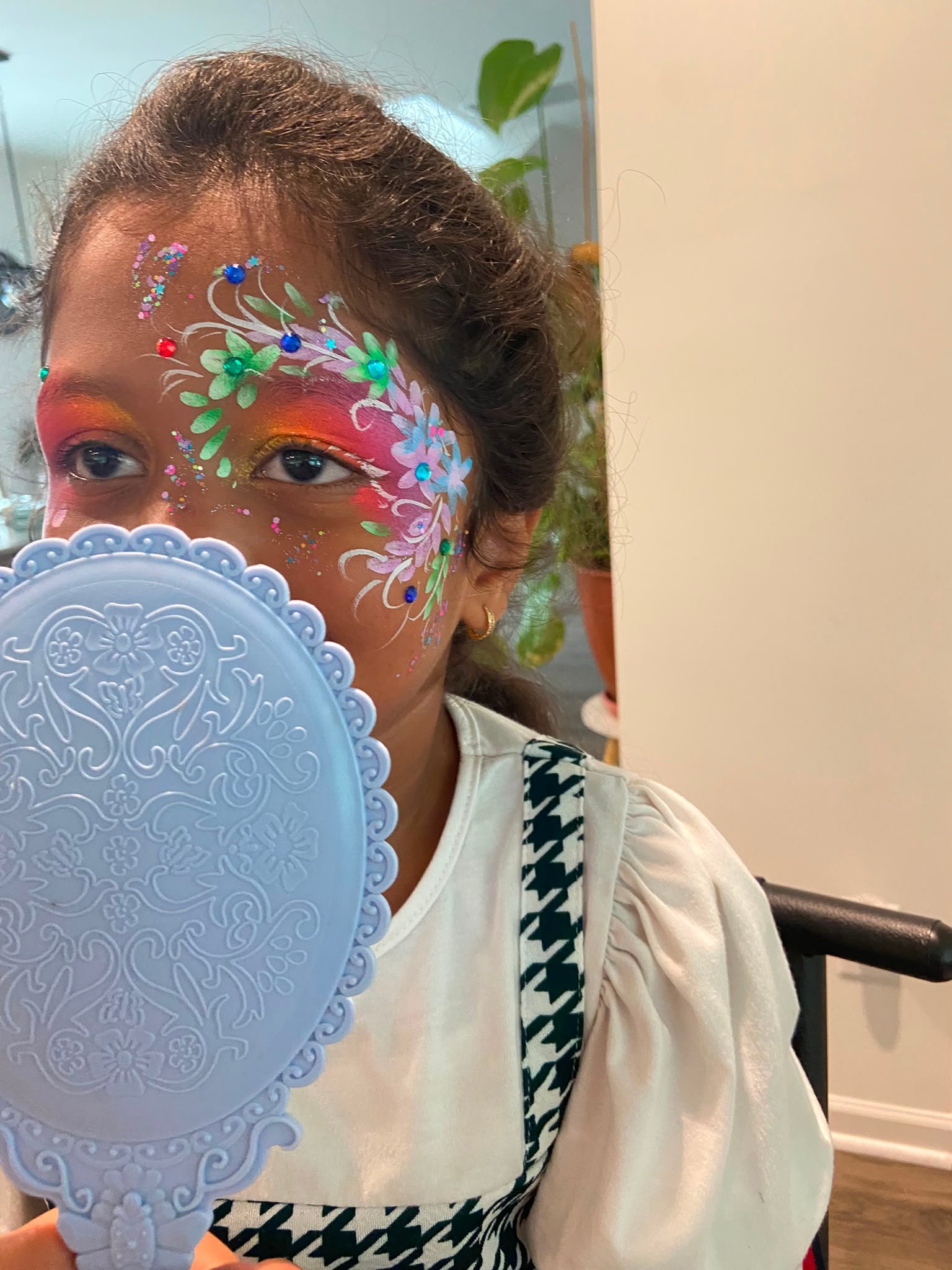 Colorful floral vines and flower crown face paint design in Apex